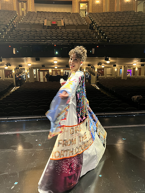 Afra Hines stands onstage, her back to the house seats, in the Legacy Robe.