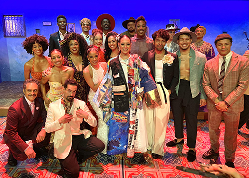 Vazquez wears the Robe, posing onstage in a group shot of 19 people.