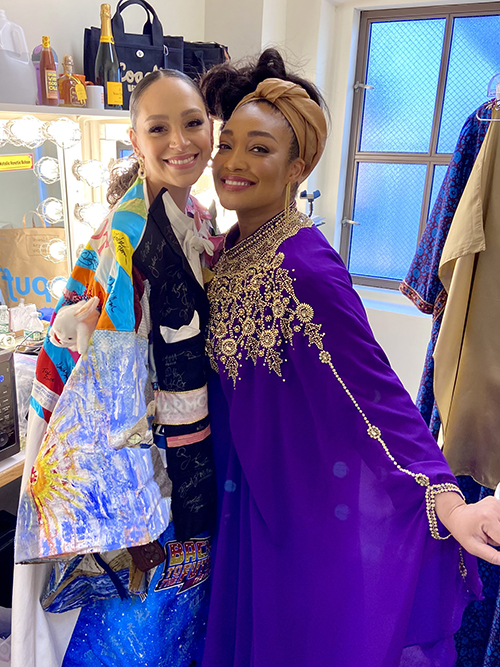 Vazquez in the Robe and Natalie Venetia Belcon smile together backstage.