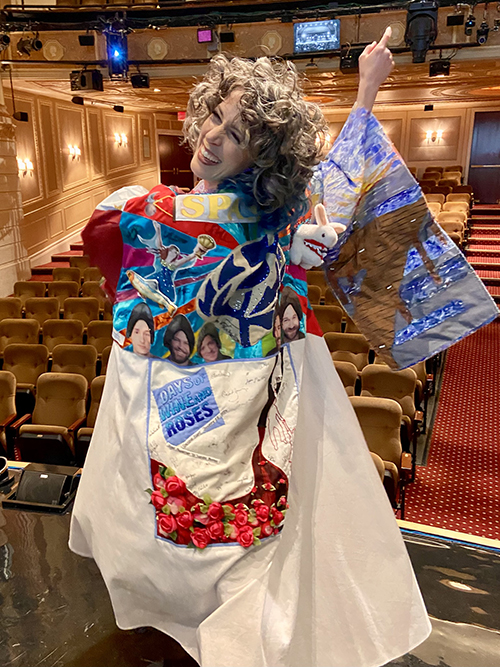 Faure stands smiling in the Robe onstage, pointing to the still-empty seats in the theater.
